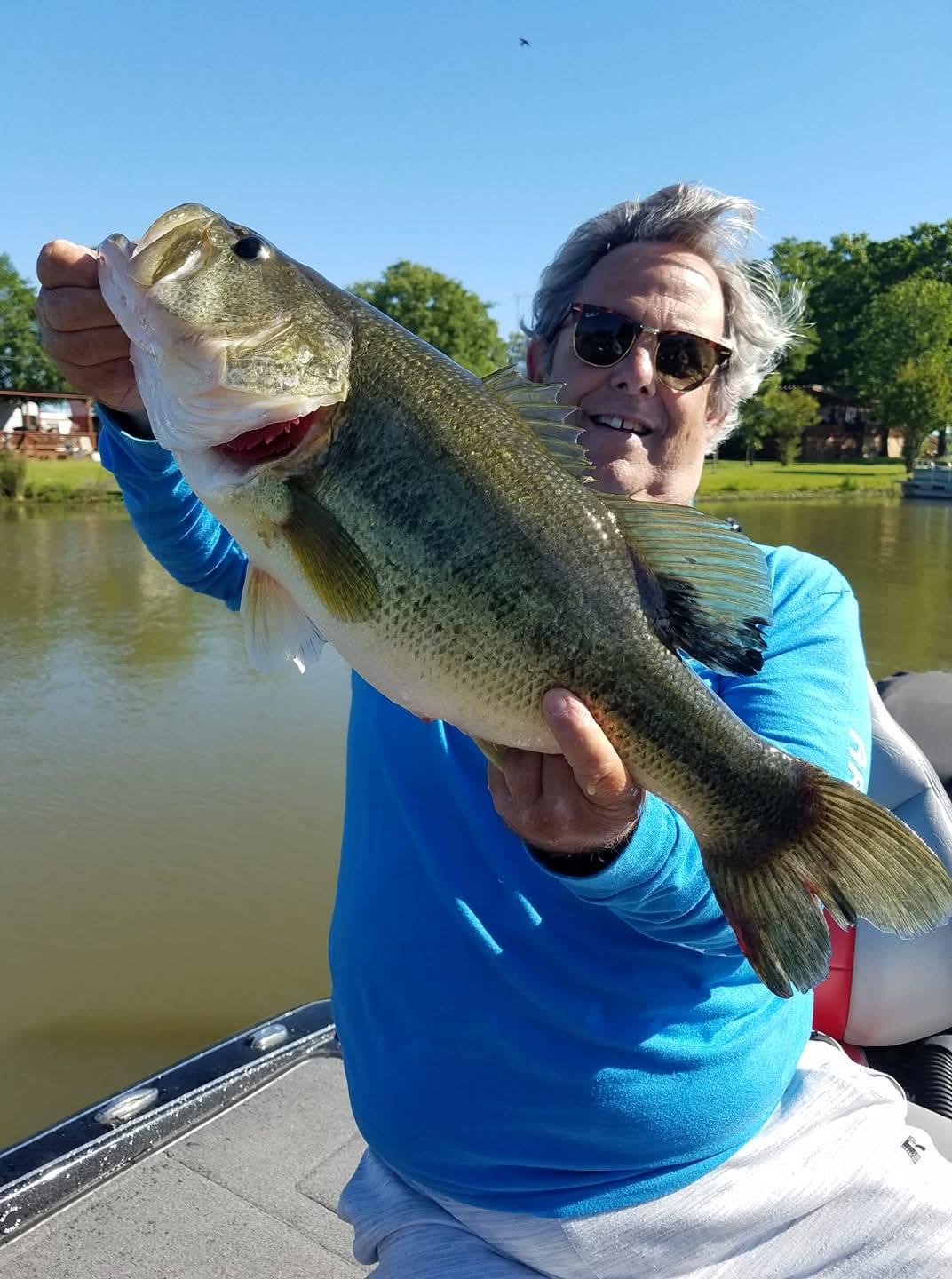 Large bass catch held up on fishing boat in Alba TX lake