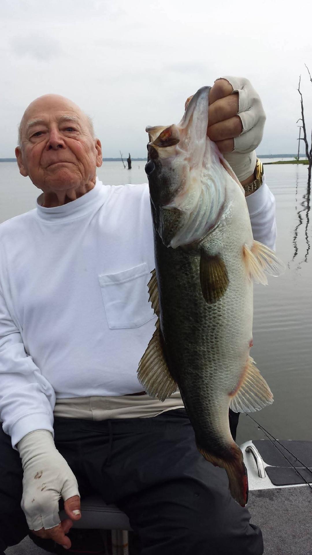 Large bass fish being held up after successful catch in Alba TX