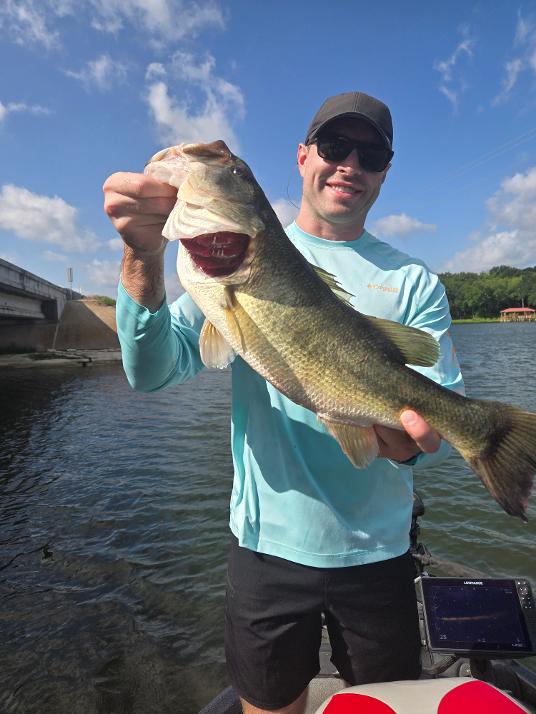 Angler holding large bass fish on lake in Alba TX