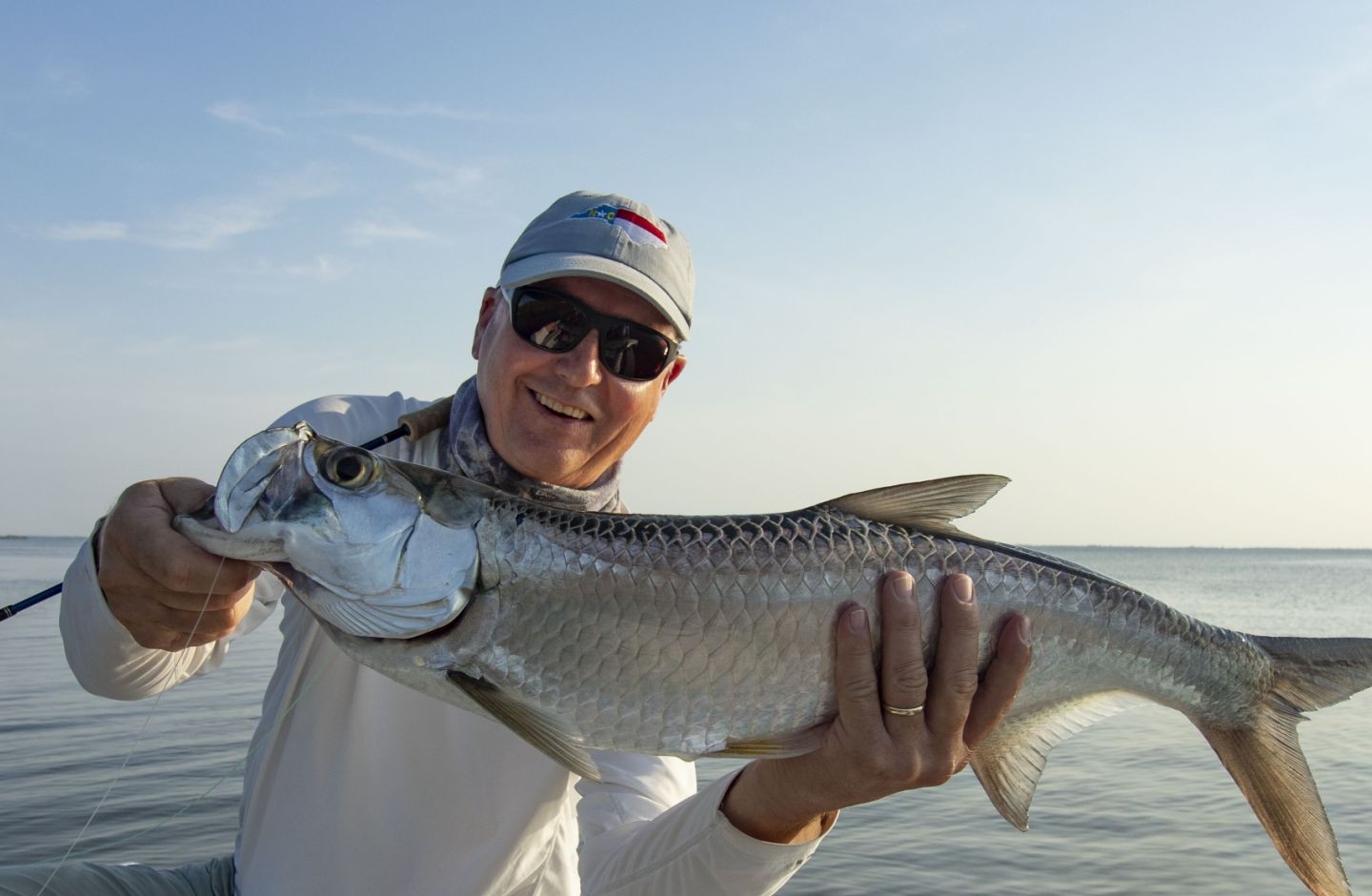 A person fishing for a large tarpon in Florida