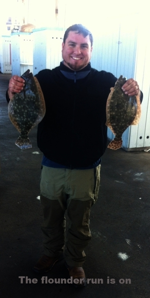 Fisherman holding two freshwater fish in Galveston