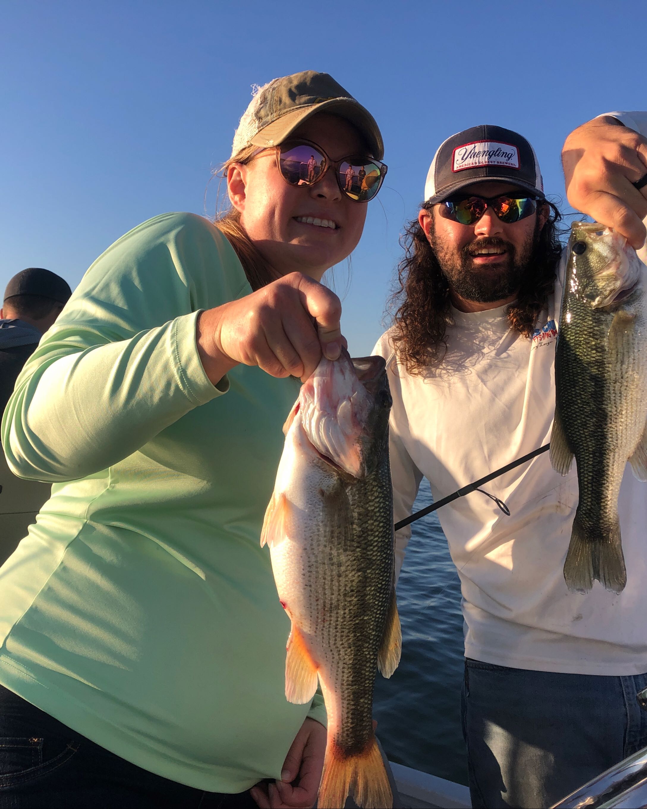 Three people fishing in Missouri with 2 big fish