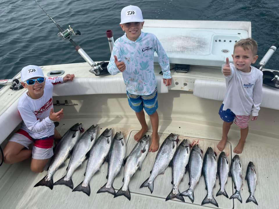 Fishing charter boat deck displaying large catch of salmon and lake trout from Olcott NY waters