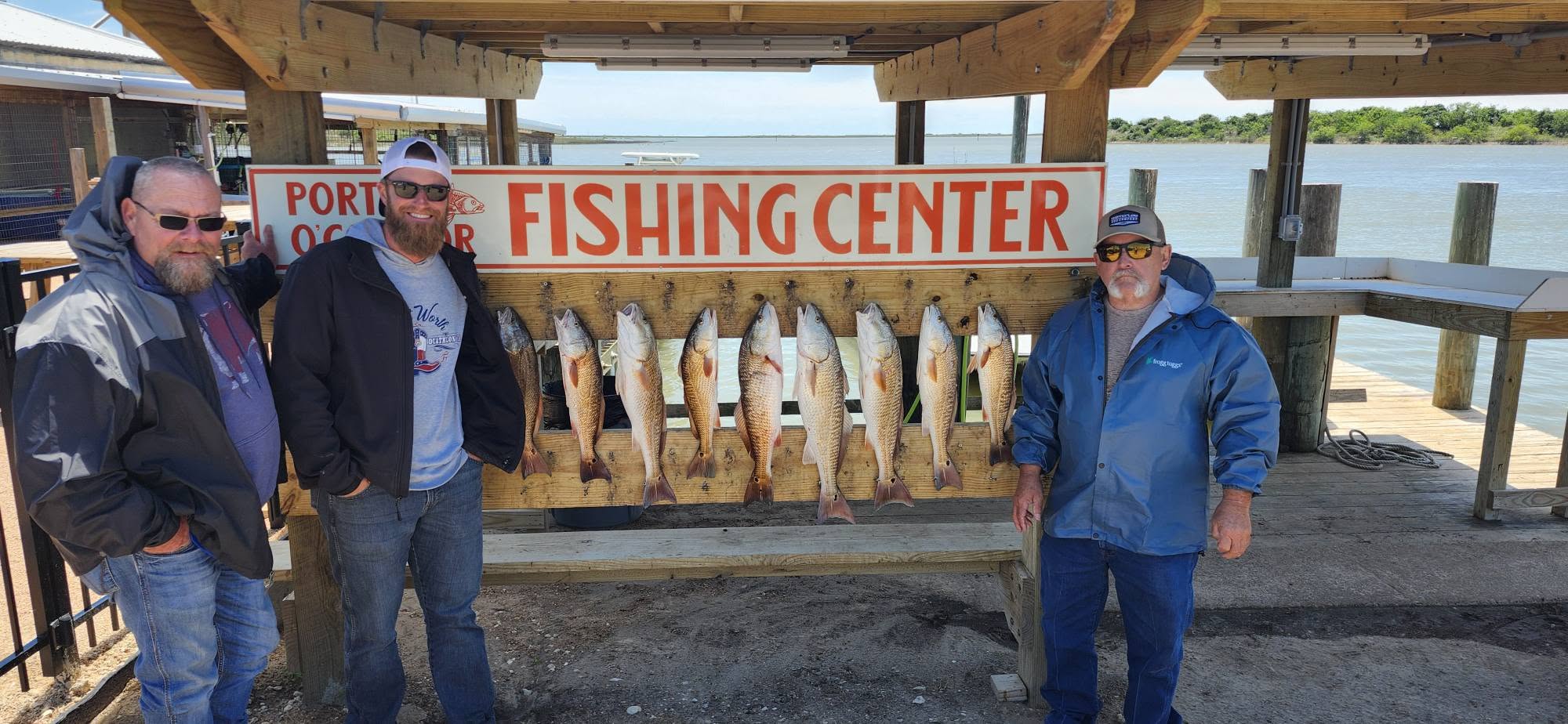 Eight redfish displayed on wooden rack at Port O'Connor TX fishing center