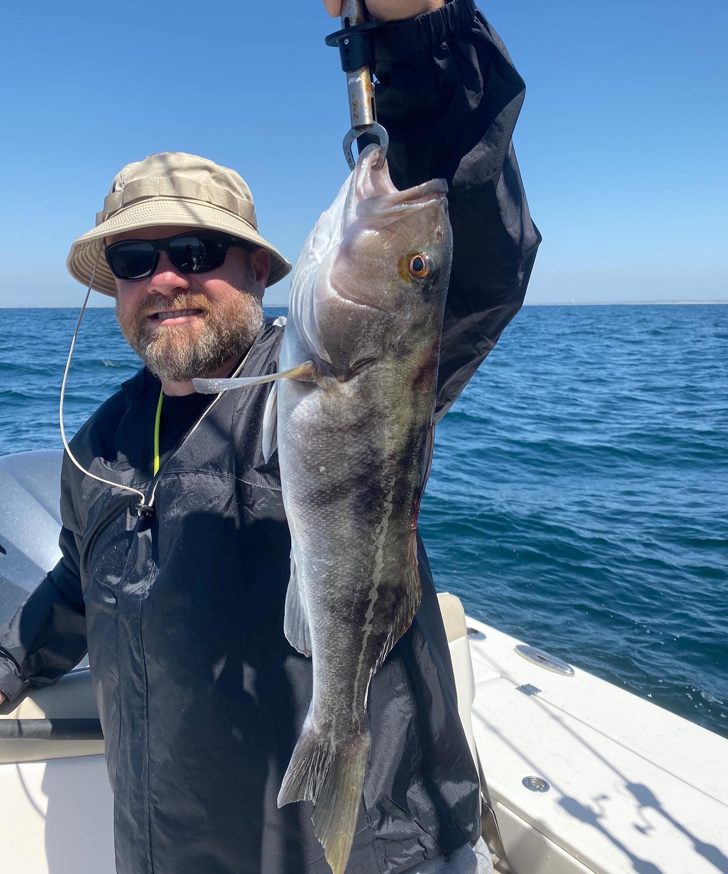 A lone fisherman catches a 17-inch fish in the beautiful state of CA.