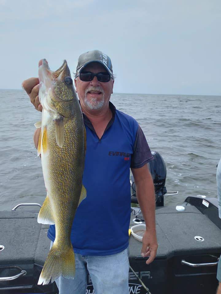 A person enjoying fishing in Kaukauna, with a 28-inch fish catch