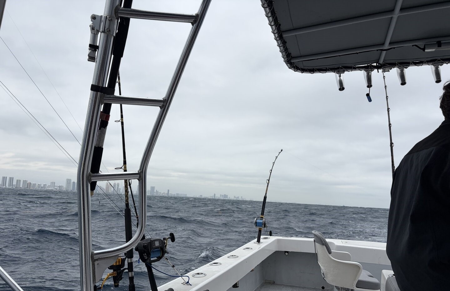 Fishing boat on ocean waters with fishing rods and equipment setup near Miami Beach FL