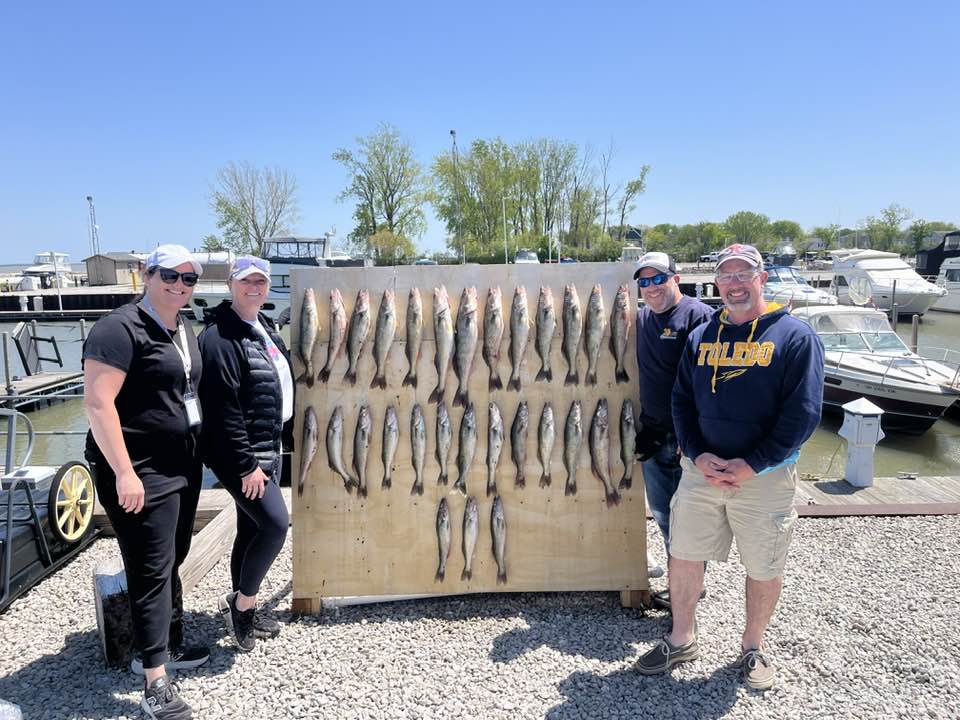 Large catch of fish displayed on board at Port Clinton OH marina with boats in background