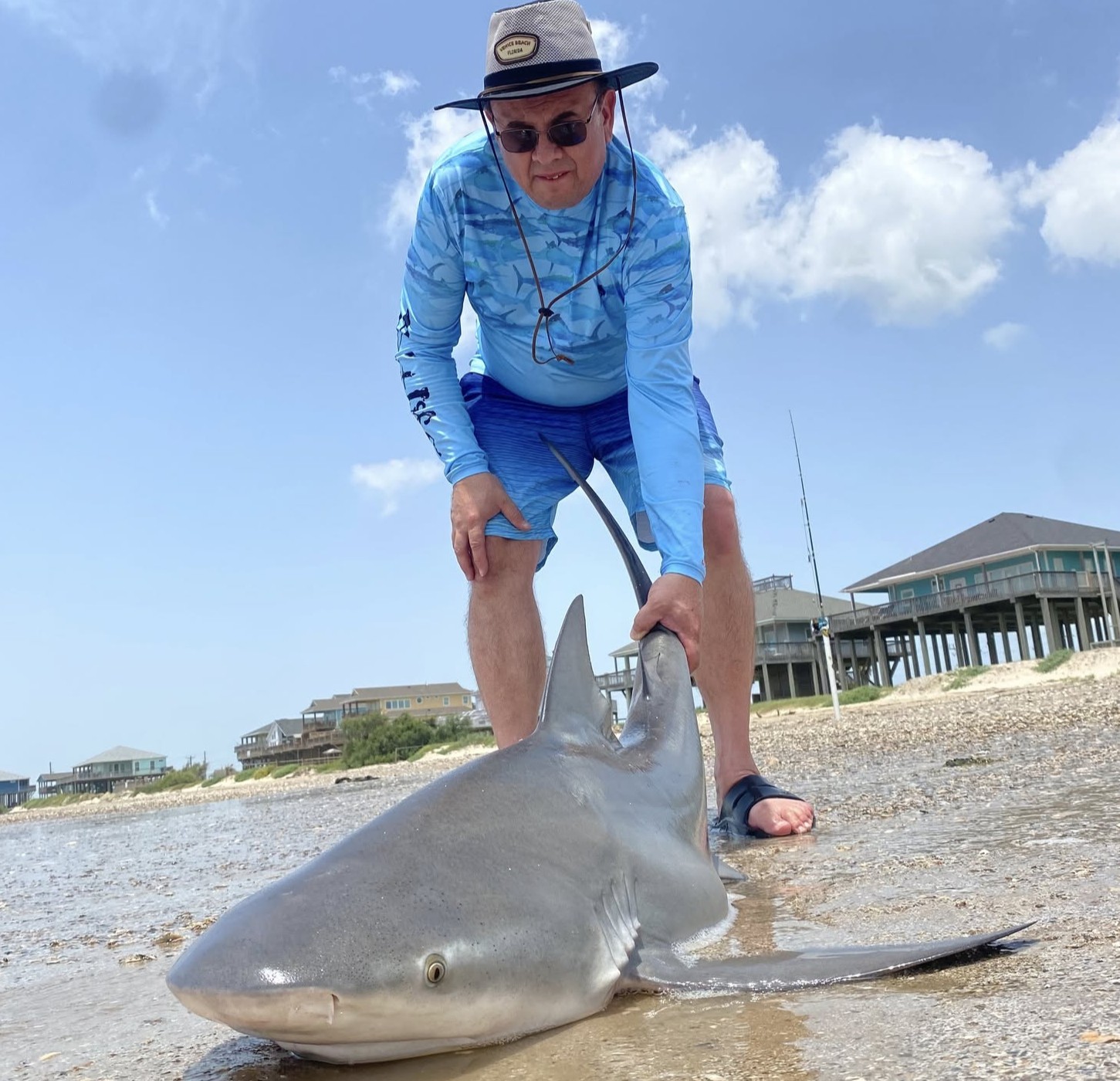 Land-based shark fishing from Bolivar beach with heavy tackle and drone bait placement in Texas