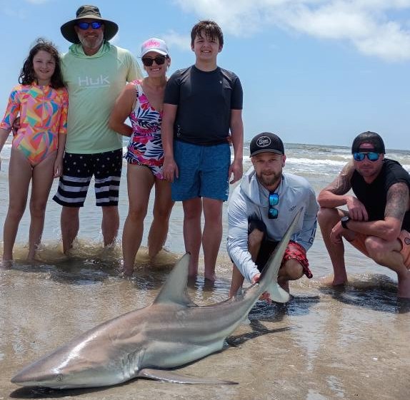 Port Aransas shore shark fishing trip with heavy tackle rods on Texas beach