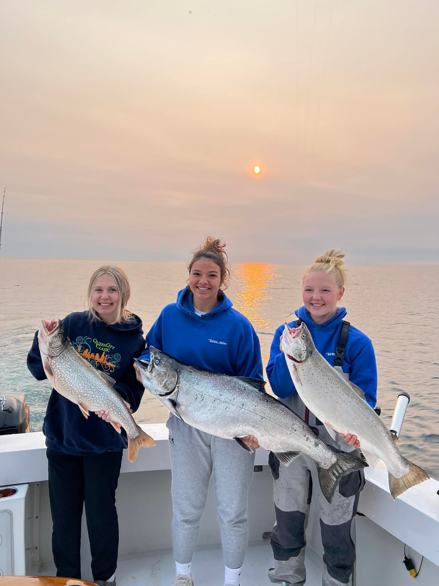 Three Chinook salmon and rainbow trout caught in Sturgeon Bay
