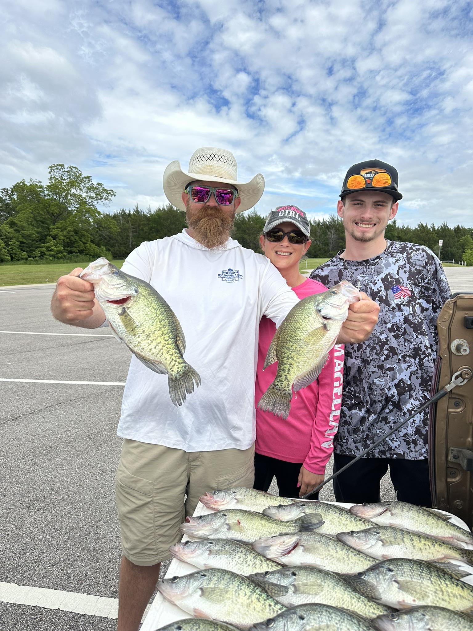 A group of 3 people fishing for 4 white crappie fish in Yantis