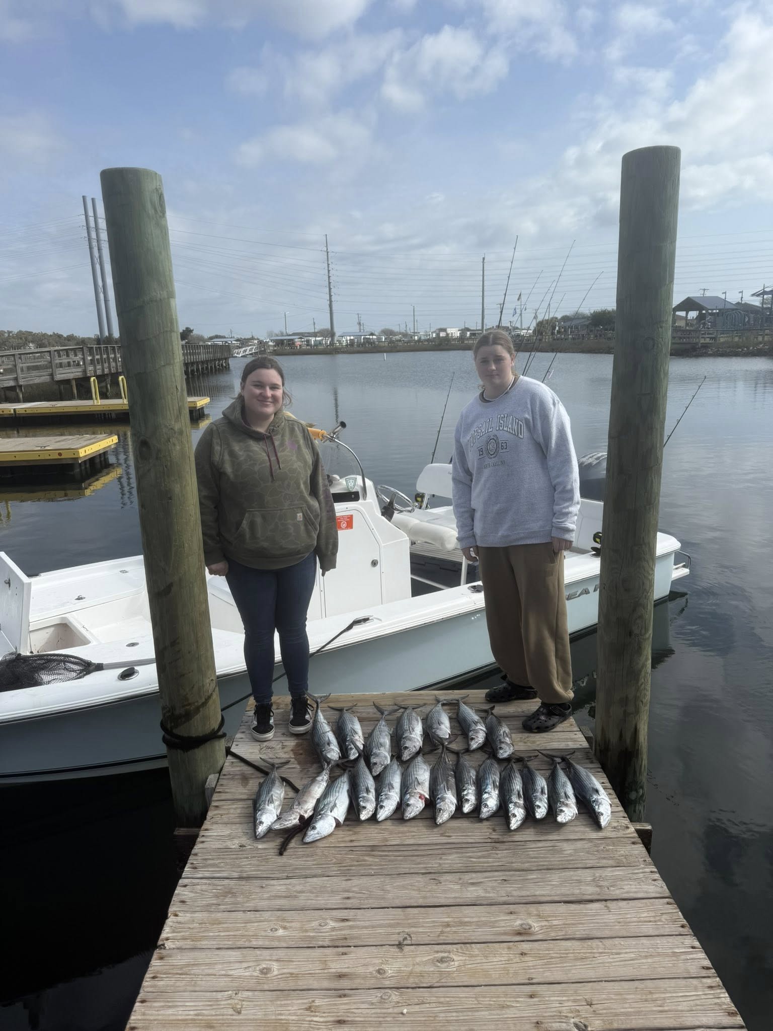 Successful fishing trip in Surf City NC with multiple fish displayed on wooden dock