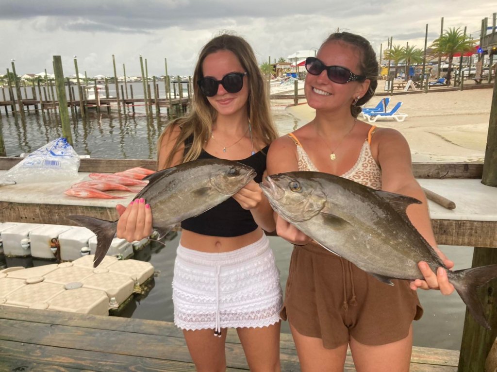 Two huge greater amberjack fish caught by two people in Orange Beach