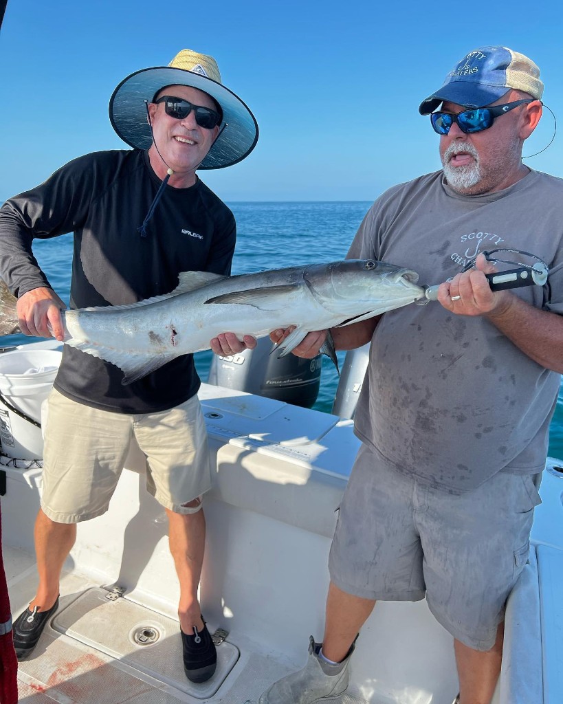 Two people fishing with a 24-inch fish in FL