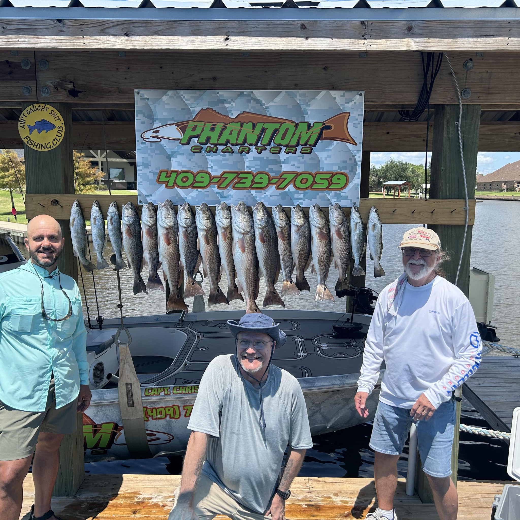 Successful fishing charter displaying multiple redfish and speckled trout caught in Bridge City TX