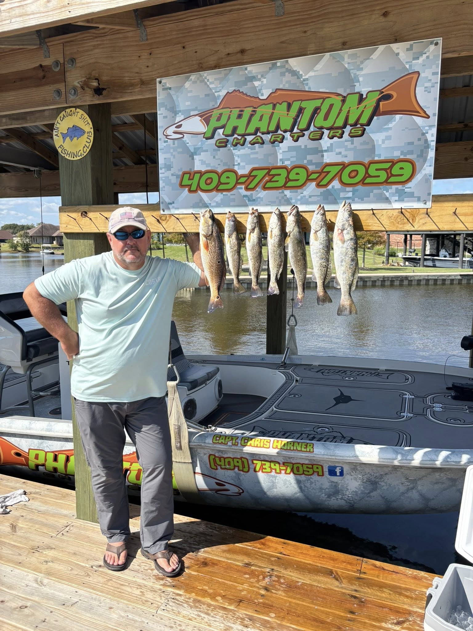 Successful fishing trip in Bridge City TX with multiple speckled trout and redfish displayed on charter boat