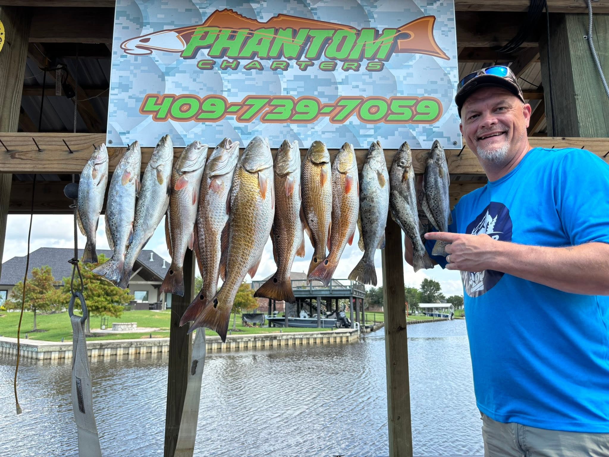 Successful fishing charter displaying speckled trout and redfish catch in Bridge City TX