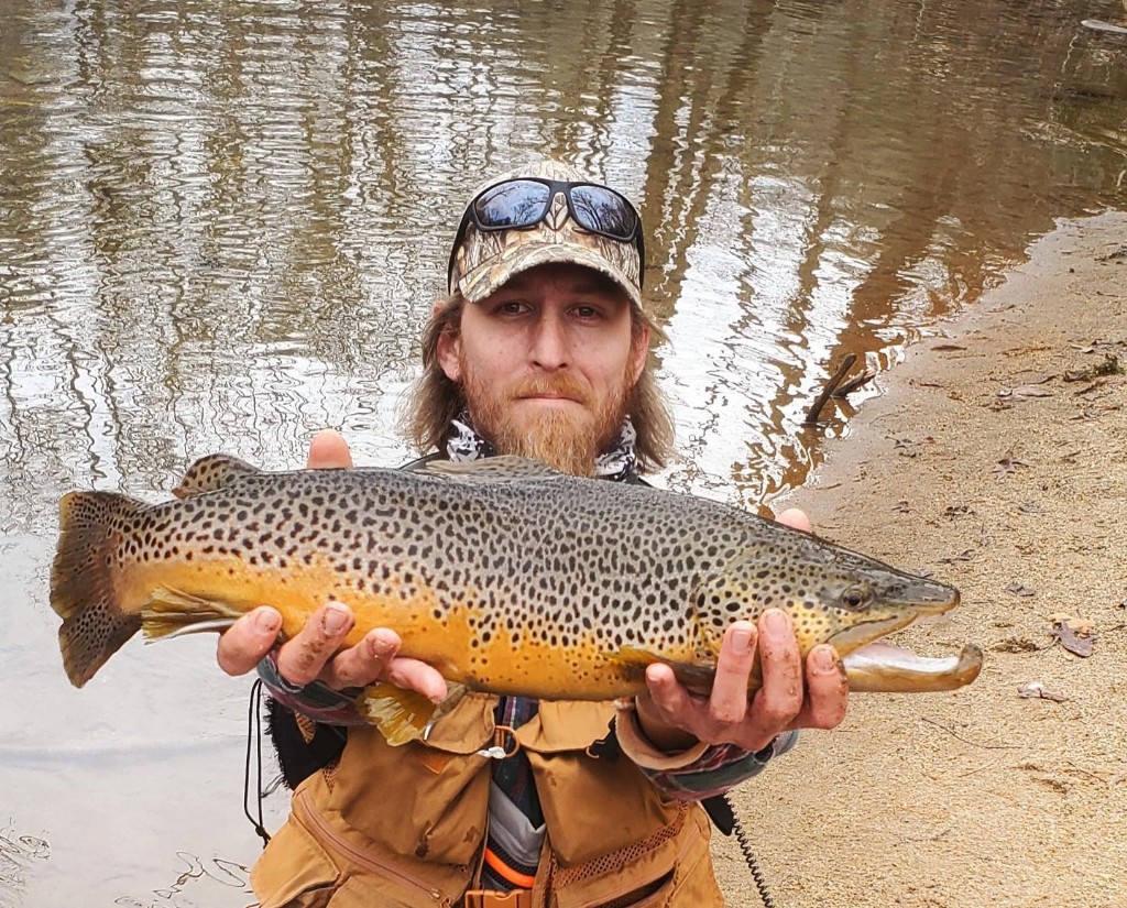 Angler with a 21-inch fish in Travelers Rest