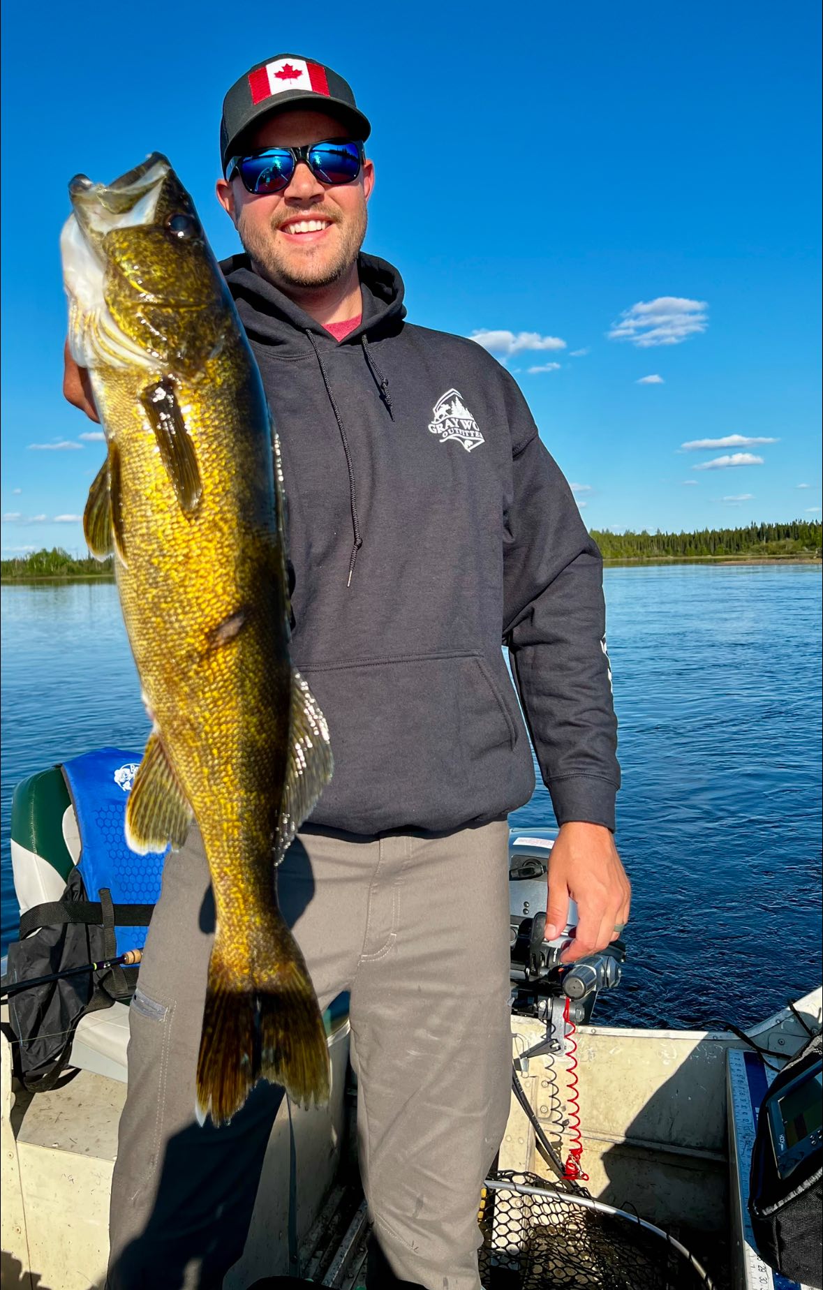 Fisherman holding large 33-inch catch in Ontario