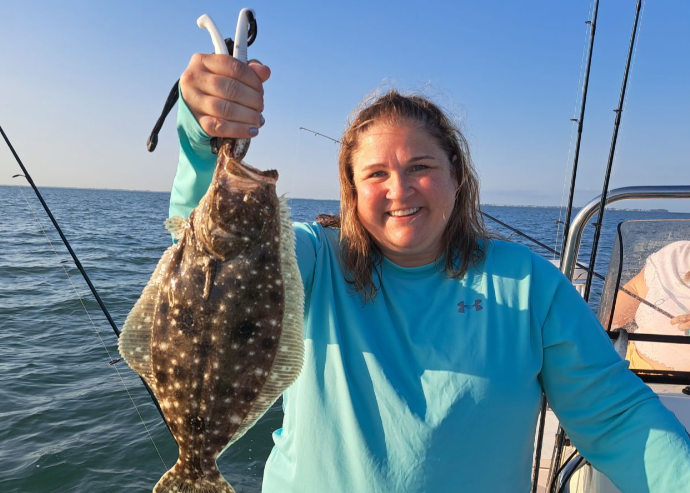 A fisherman catches a Summer Flounder in FL