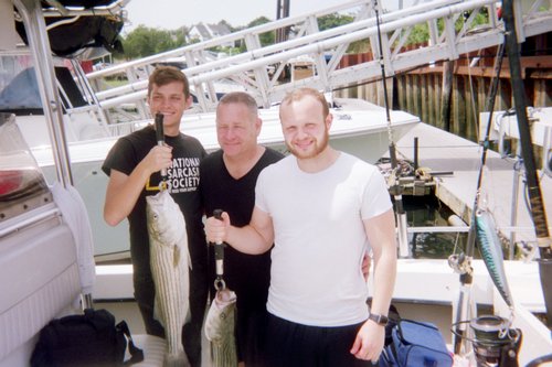 A group of 3 people fishing with rods in East Dennis