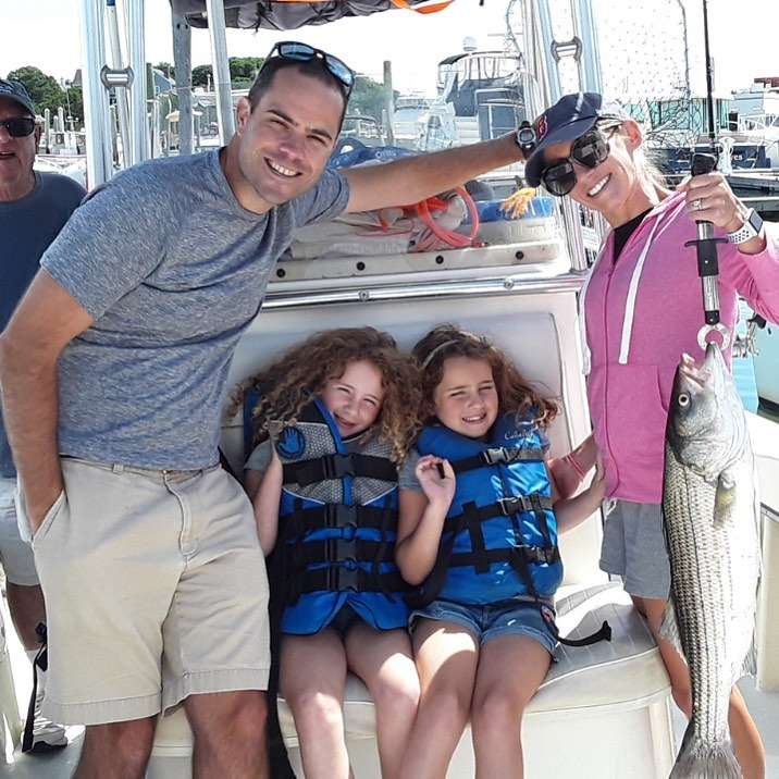 Kids fishing for striped bass and bluefish on Cape Cod Bay charter boat from Sandwich, MA