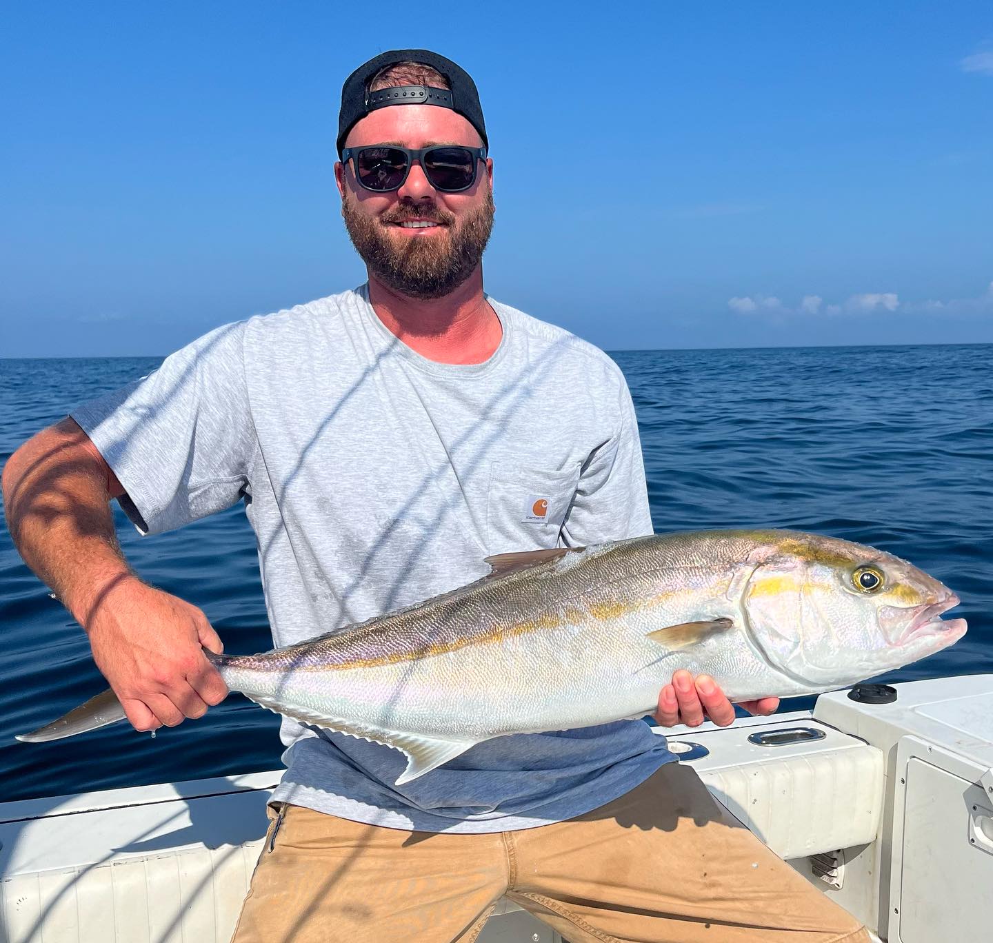 One fisherman holding a 23-inch fish in Wanchese