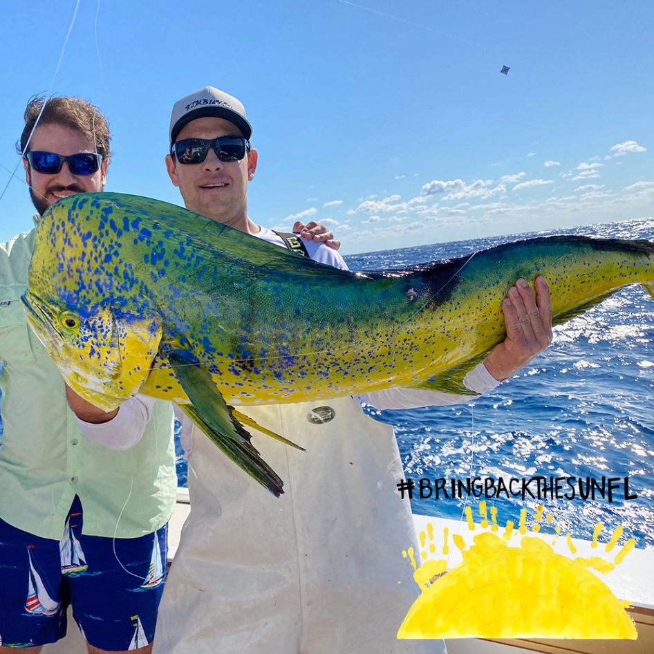 2 people holding a 36-inch fish in FL