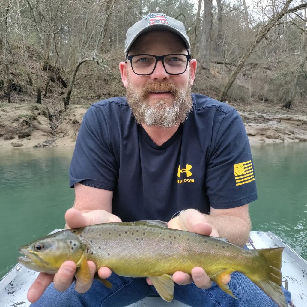 Angler holding a rainbow trout in Arkansas