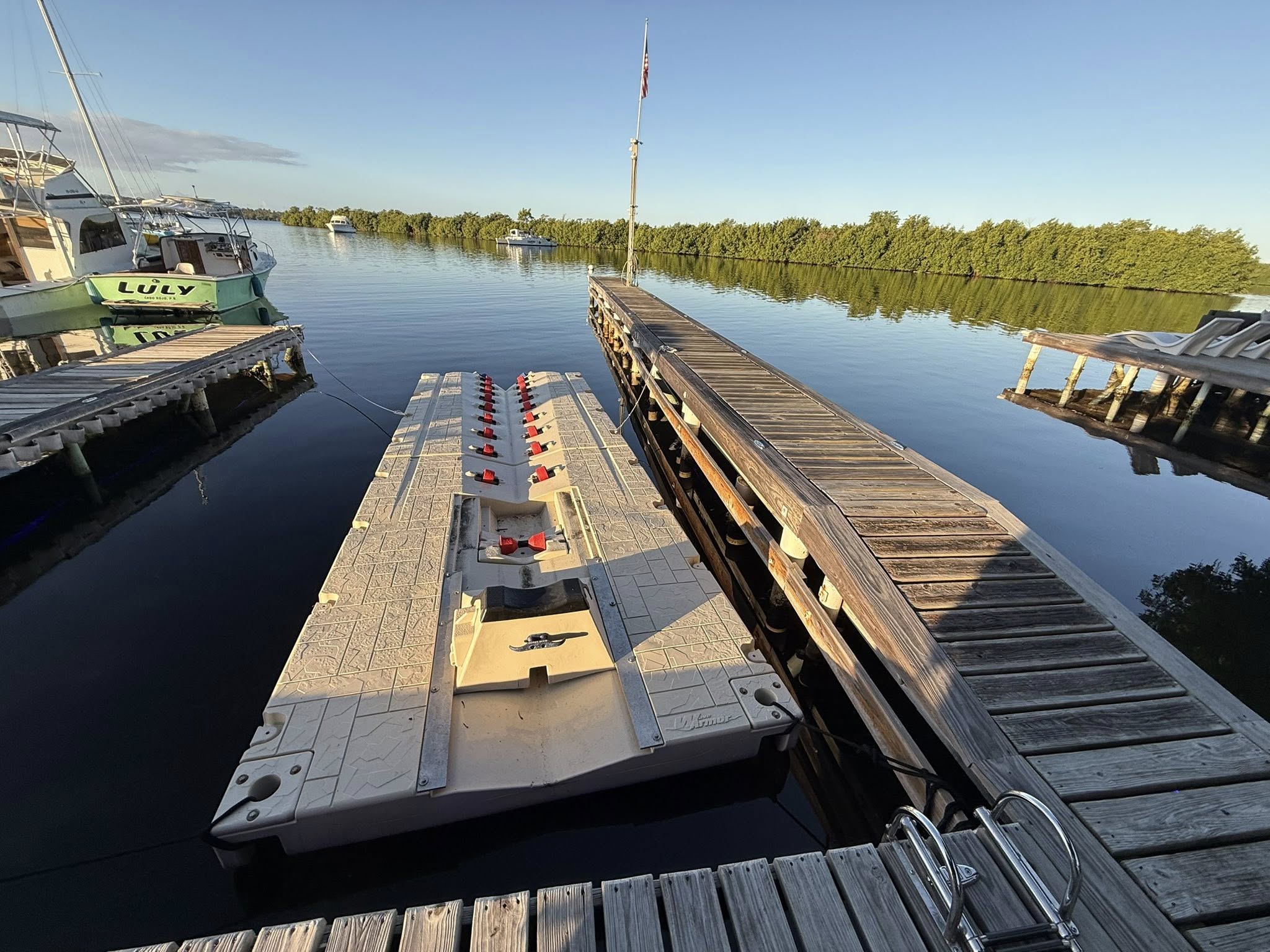 Fishing dock setup with tackle box and equipment at marina in Cabo Rojo PR