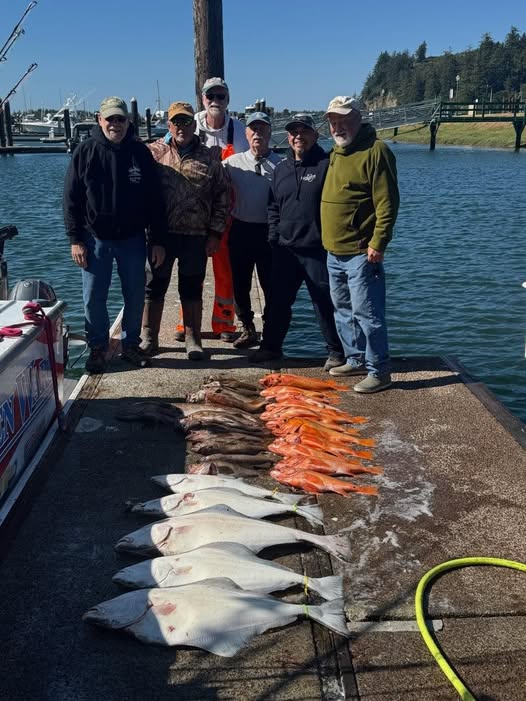Successful fishing charter displaying Pacific Halibut and mixed catch on dock in Roseburg OR
