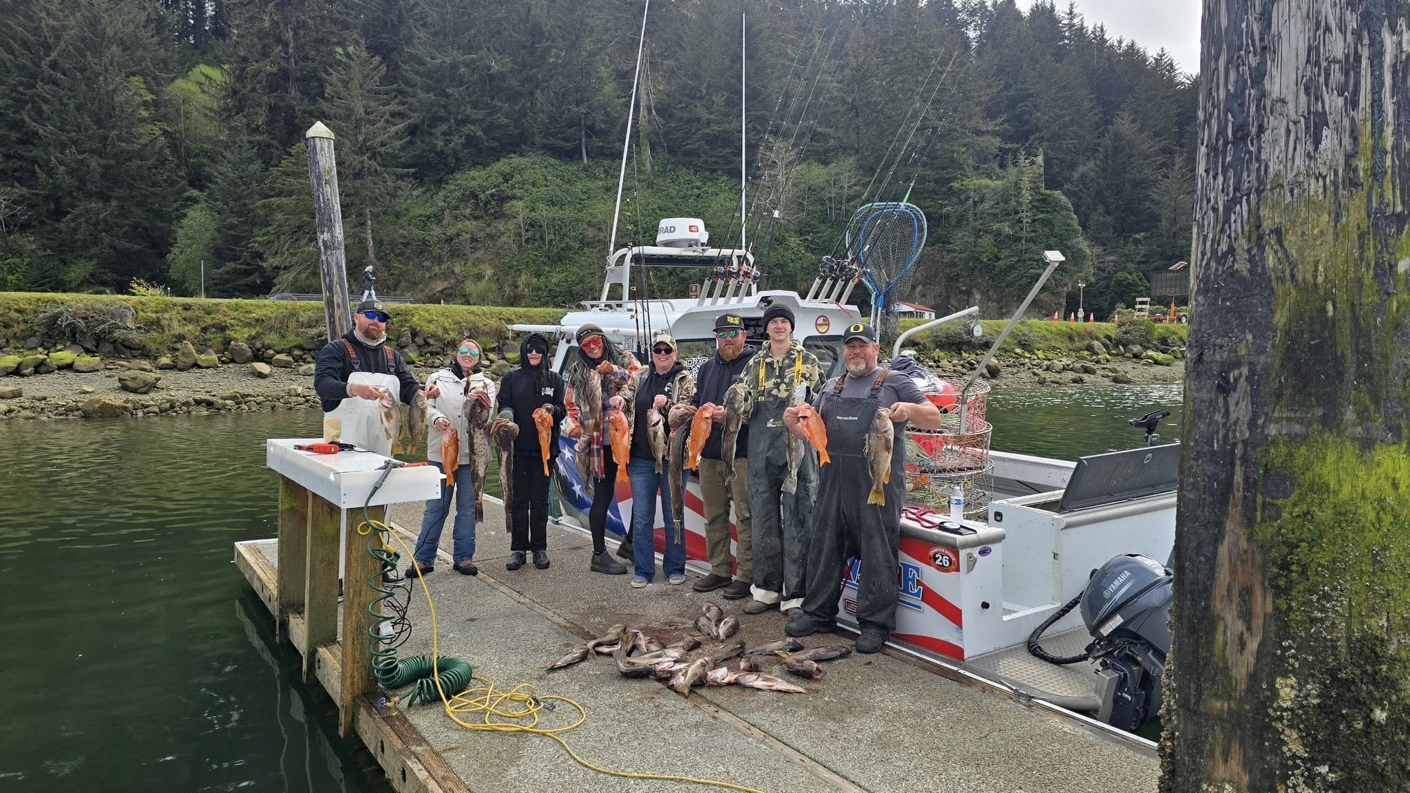 Successful fishing group displaying their catch on dock in Roseburg OR with charter boat