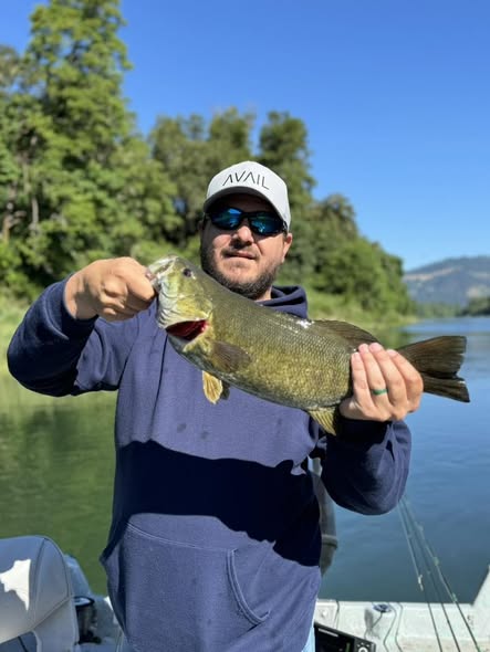 Freshly caught smallmouth bass held up after successful fishing trip in Roseburg Oregon