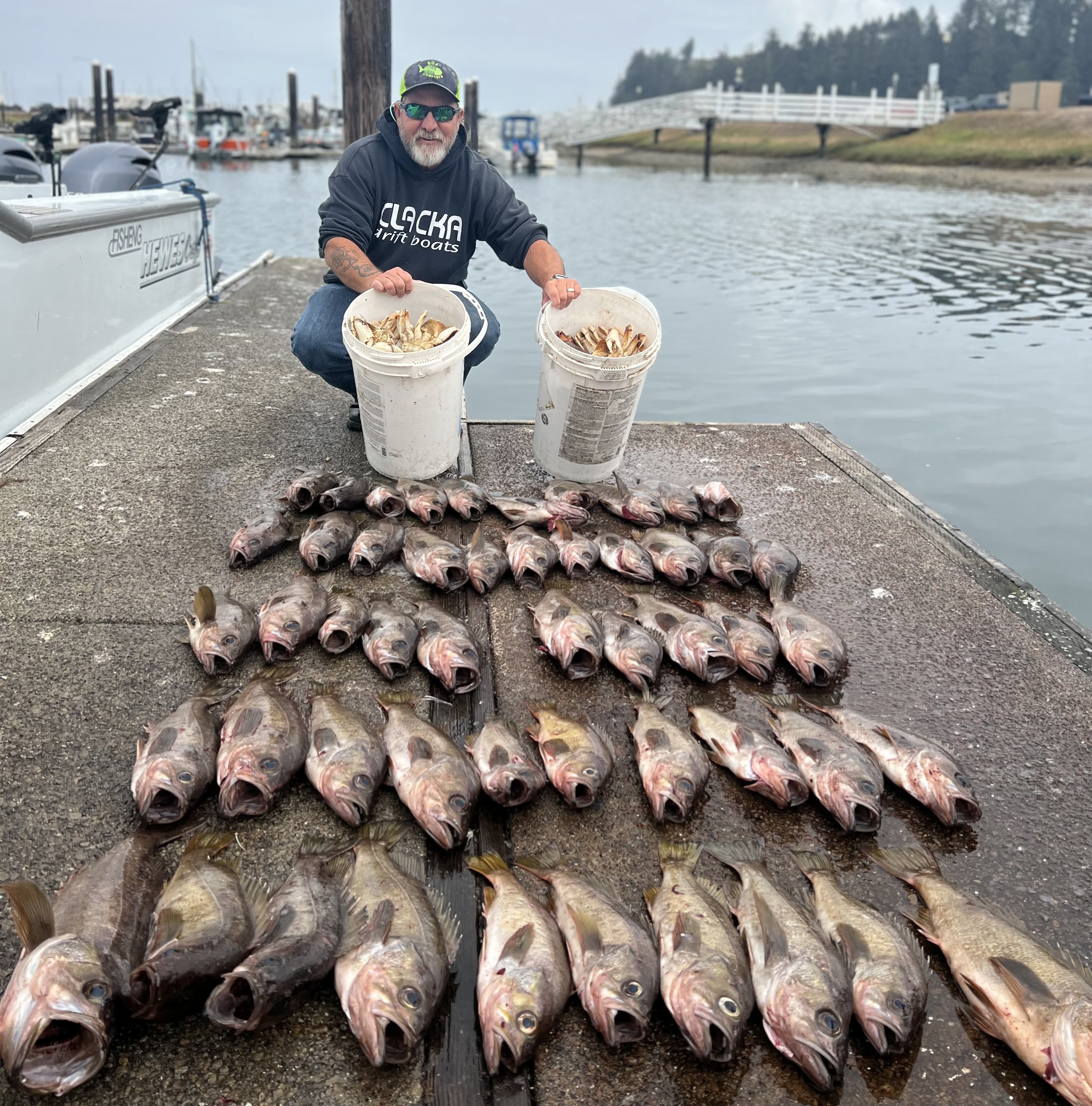 Rockfish crabbing combo offshore fishing charter boat with crew pulling crab pots from ocean