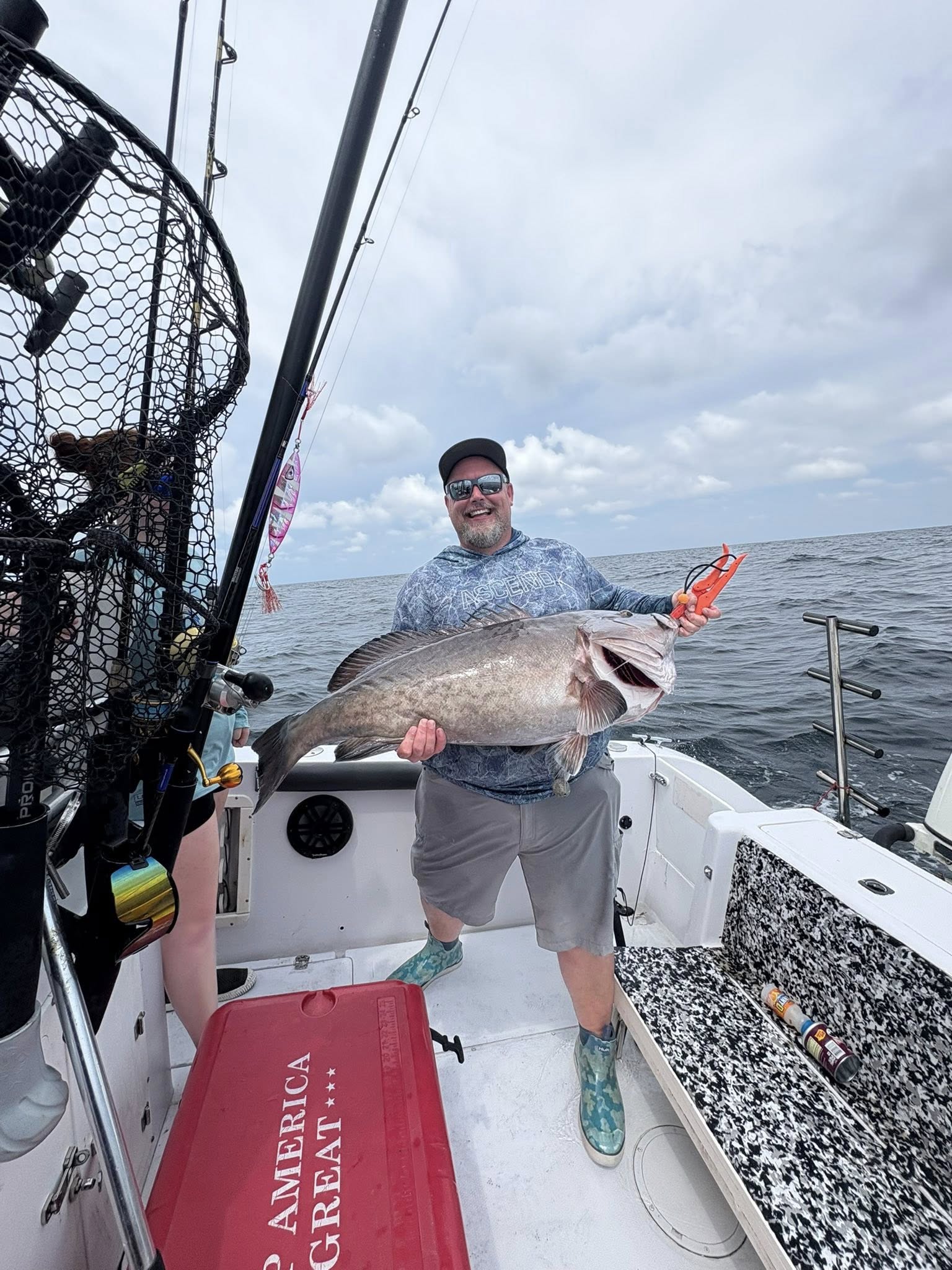 Angler holding large gag grouper on fishing boat in Panama City FL waters