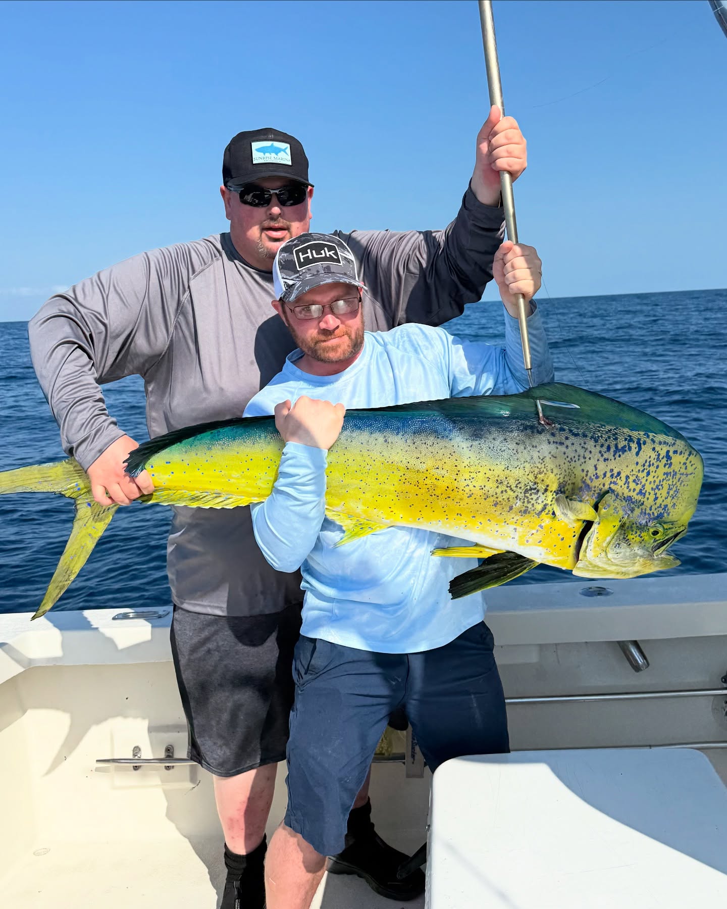 Two people fishing in FL, with a 22-inch fish