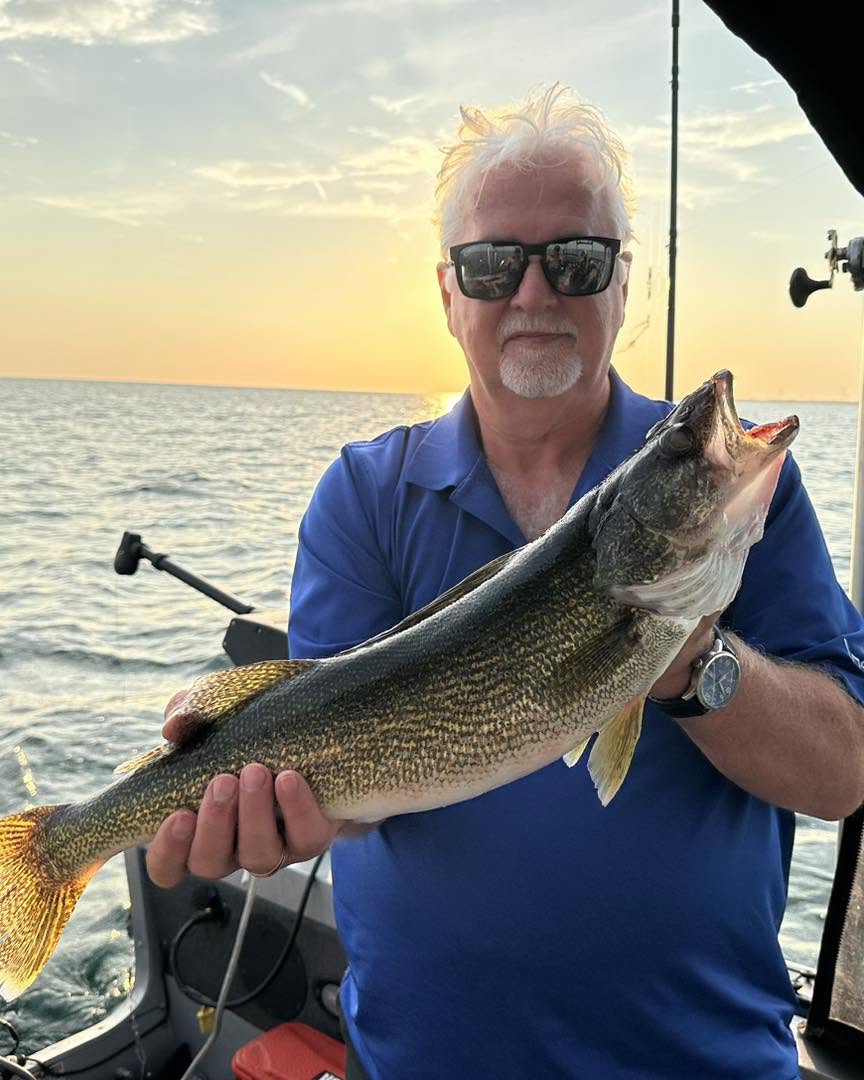 Lake Erie walleye fishing charter boat with anglers and gear on water near Port Maitland