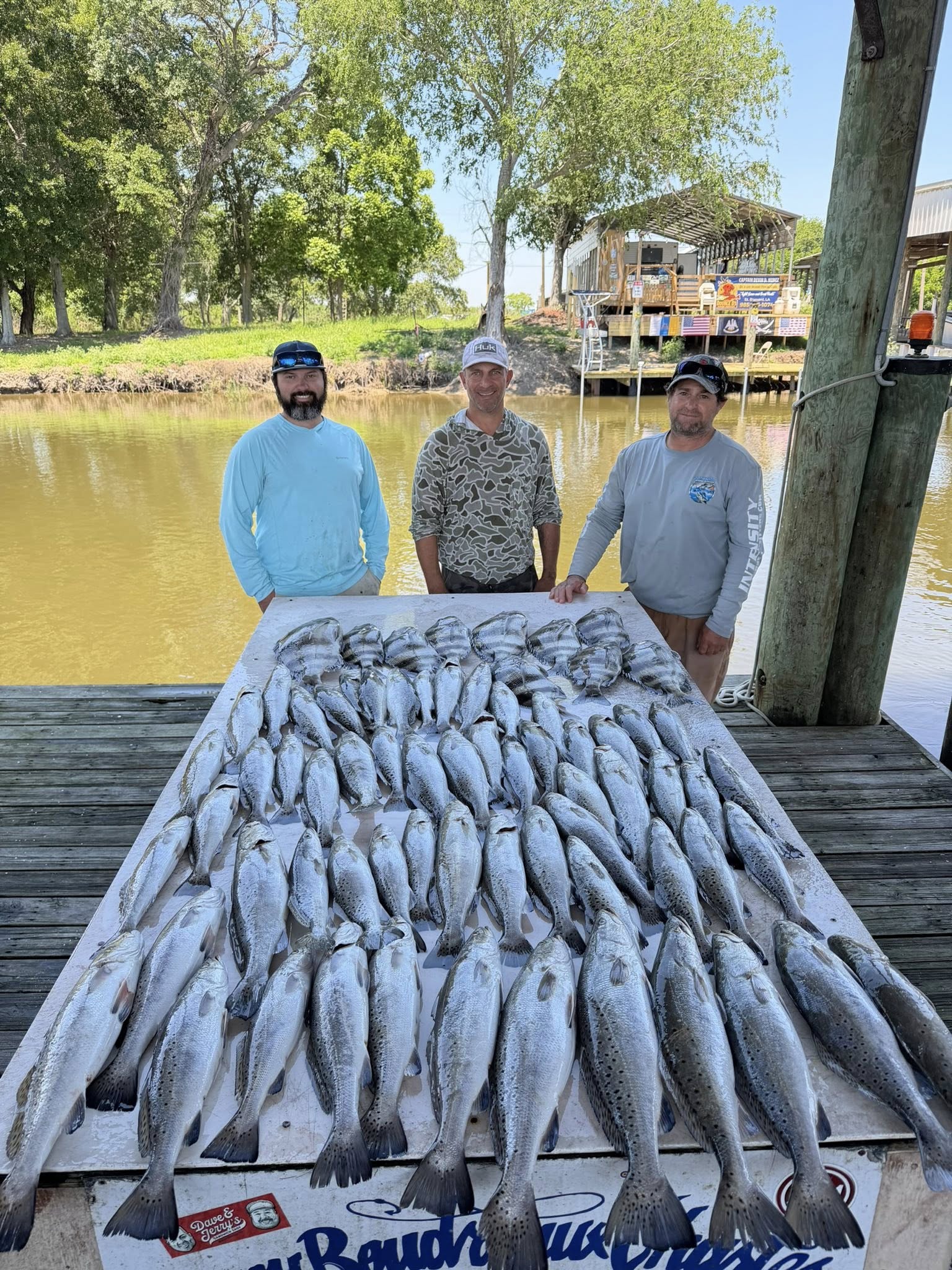 Large catch of speckled trout displayed on wooden dock in St Bernard Louisiana