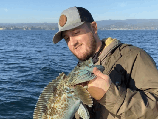 One person holding a fish in CA