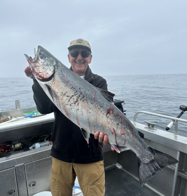 A lone fisherman reeling in a 33-inch catch in Ketchikan
