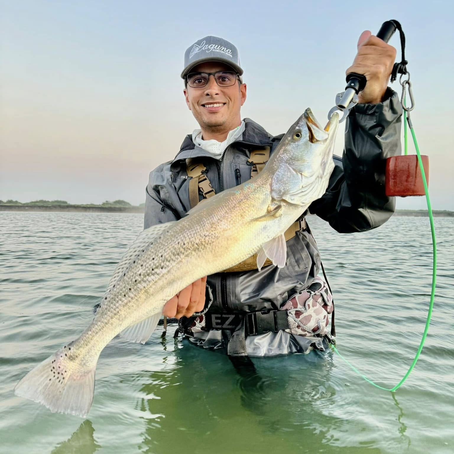 Baffin Bay fishing charter boat with anglers catching trophy trout using live bait in Texas waters