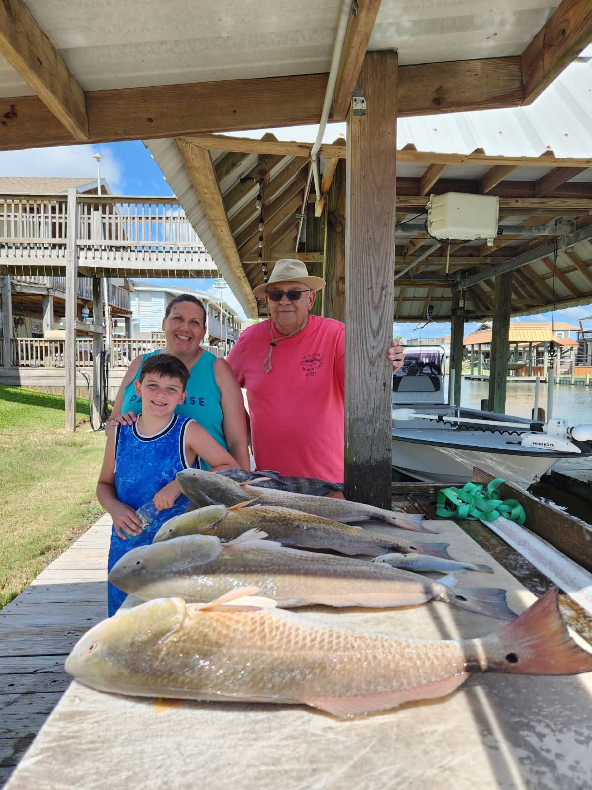 Fresh caught redfish displayed on cleaning table at Bolivar Peninsula TX fishing dock