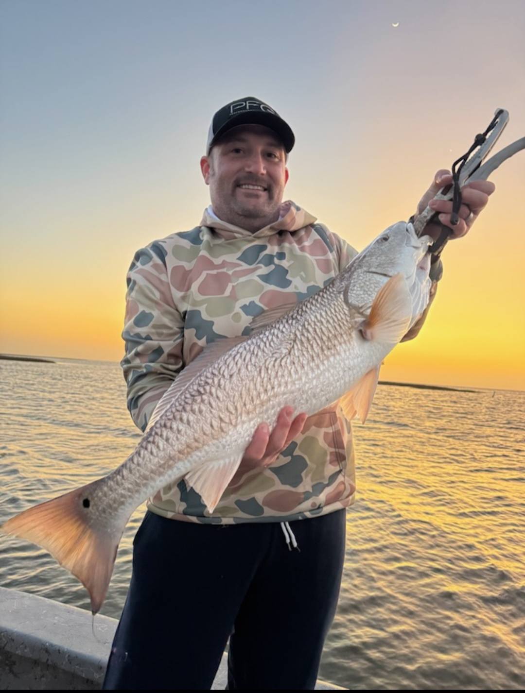 Redfish catch on Bolivar Peninsula TX fishing trip at sunset