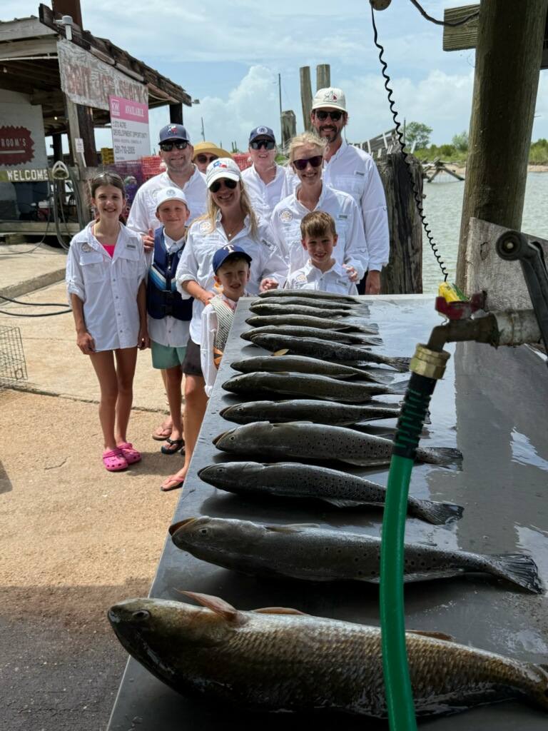 Successful fishing trip with redfish and speckled trout catch displayed at Bolivar Peninsula TX dock