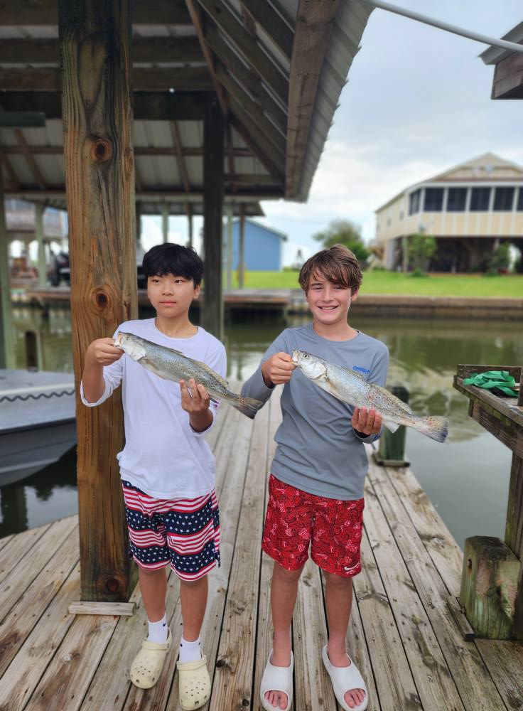 Two speckled trout caught fishing on Bolivar Peninsula TX dock