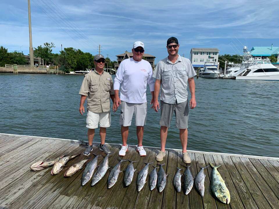 A group of 3 people enjoying a fishing trip in North Carolina