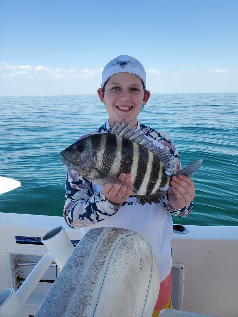 A fisherman holding a 15-inch Sheepshead fish in Florida