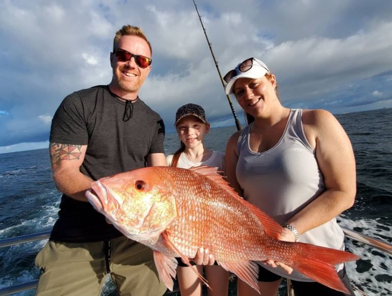Three anglers fishing at scenic Orange Beach