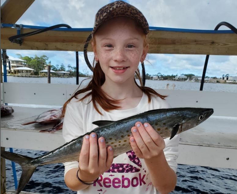 Fisherman catching a Spanish Mackerel in Orange Beach